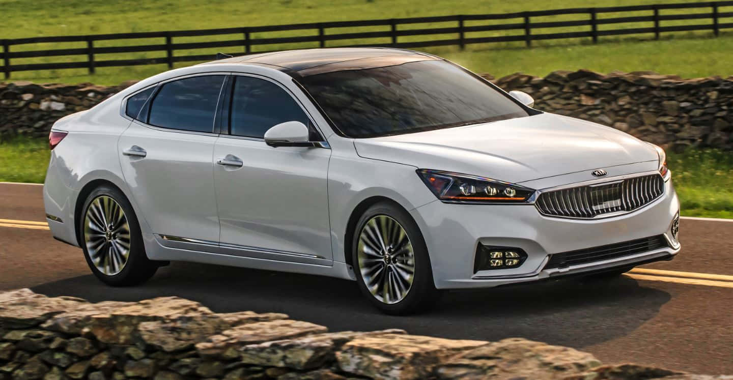 Sleek And Modern White Kia Cadenza In Action Wallpaper