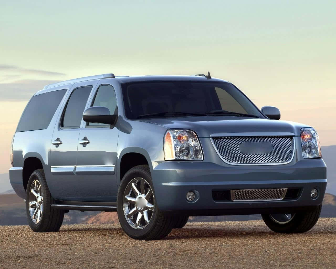 Sleek And Powerful Gmc Yukon On The Road Wallpaper