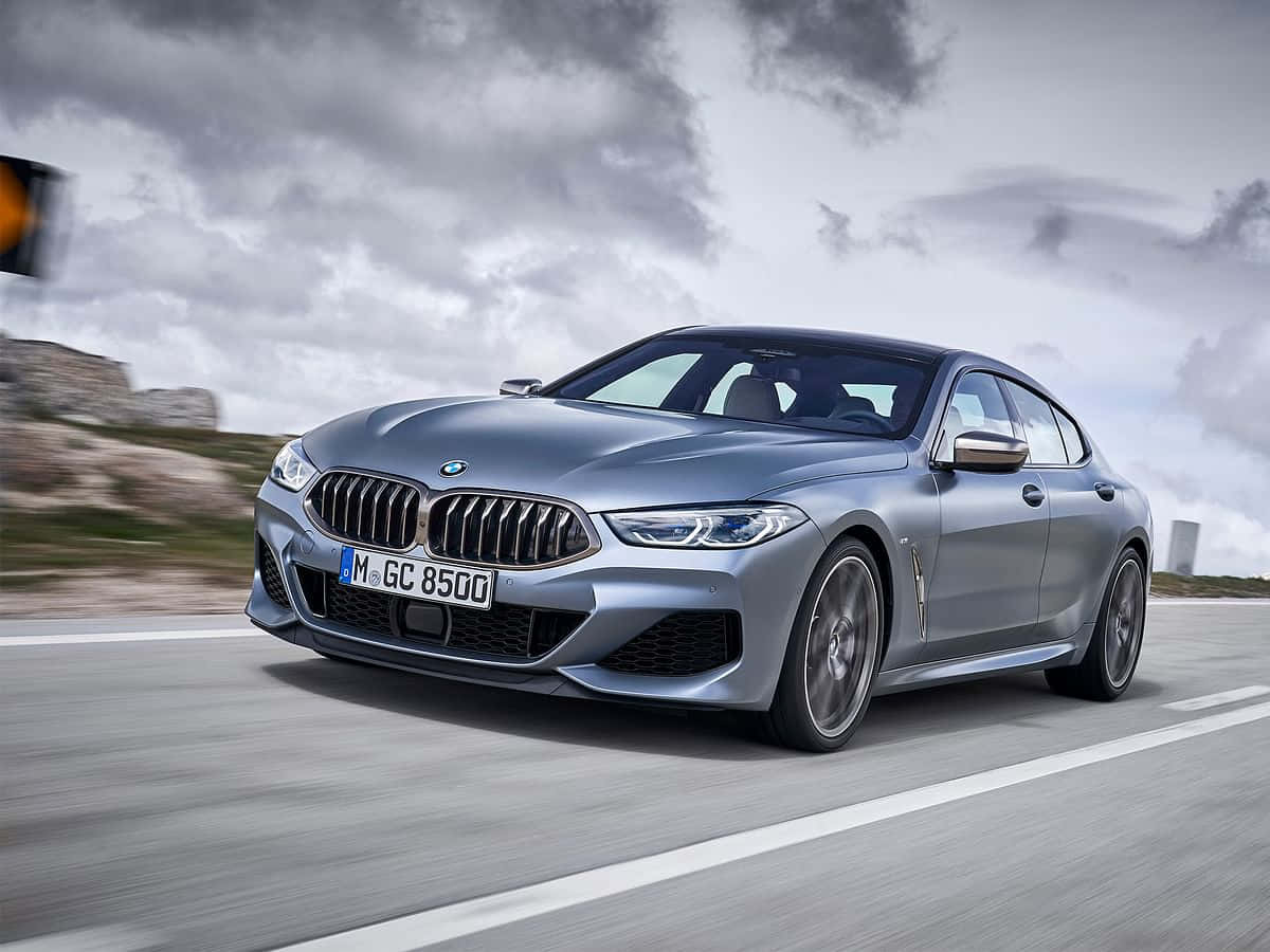 Sleek And Powerful New Bmw 8 Series On The Road Wallpaper