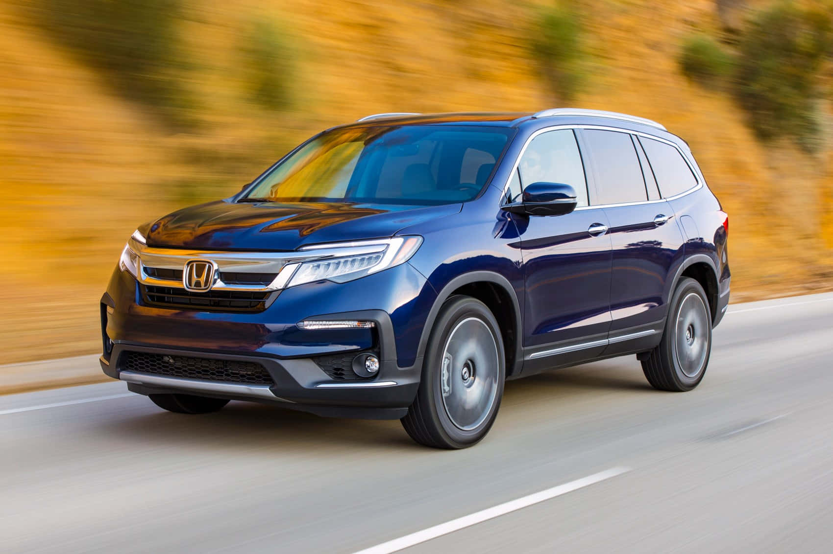 Sleek And Spacious Honda Pilot On The Road Wallpaper