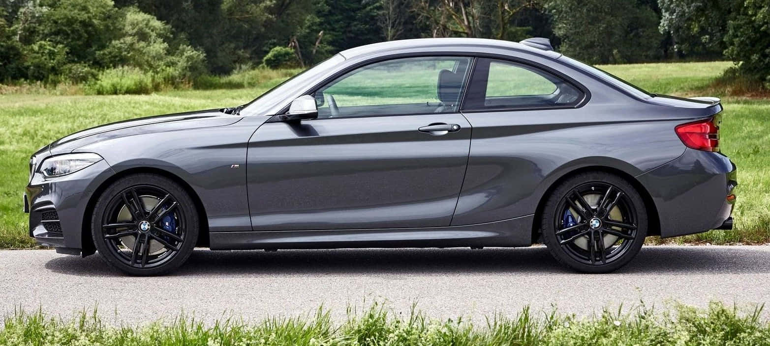 Sleek And Stylish Bmw 2 Series In Action Wallpaper