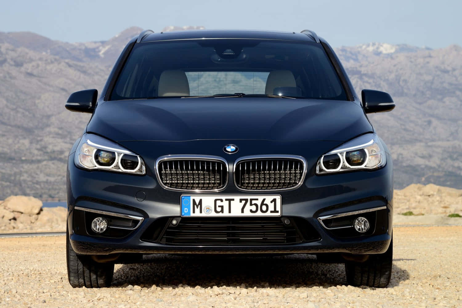 Sleek And Stylish Bmw 2 Series On The Road Wallpaper