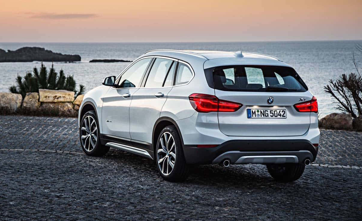 Sleek And Stylish Bmw X1 On The Road Wallpaper