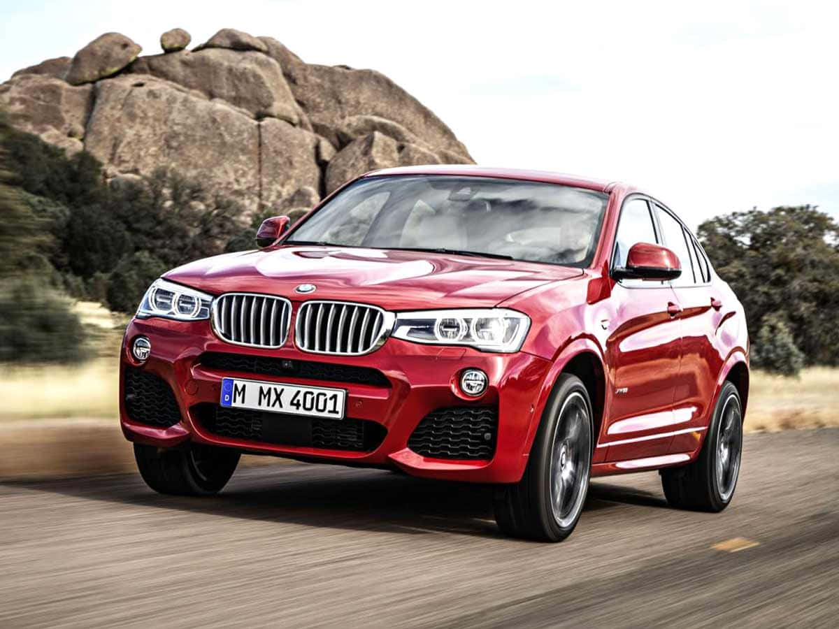 Sleek And Stylish Bmw X4 On The Road Wallpaper