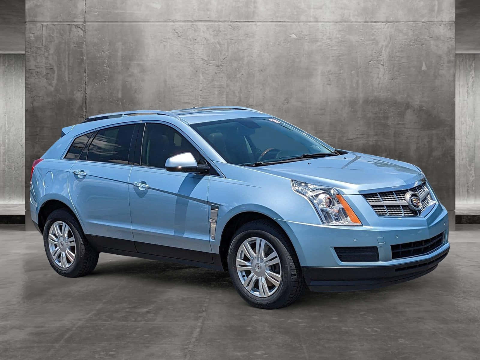 Sleek And Stylish Cadillac Srx On The Road Wallpaper