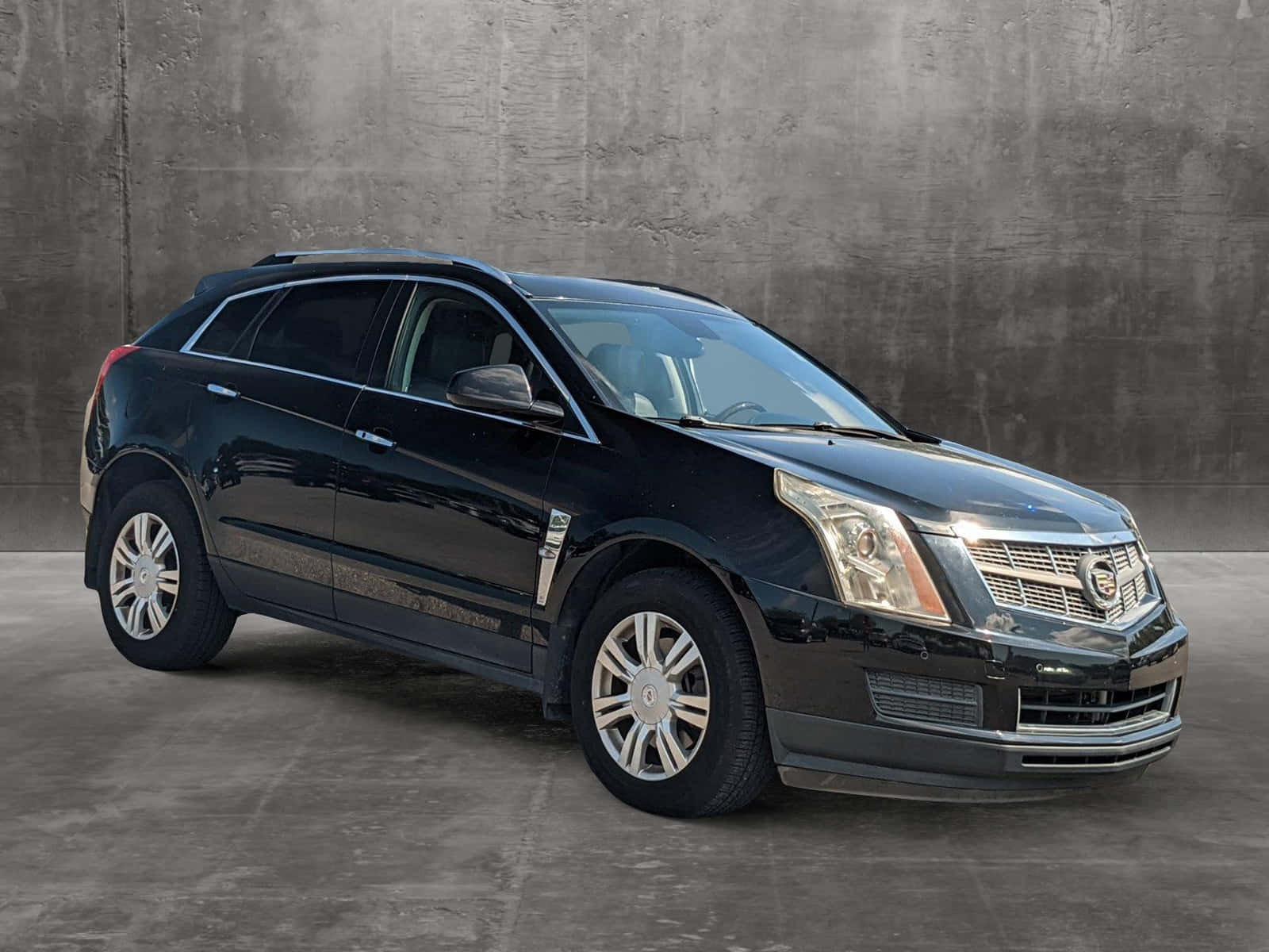 Sleek And Stylish Cadillac Srx On The Road Wallpaper