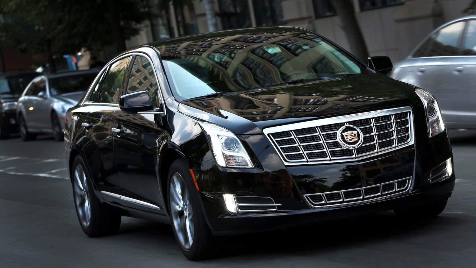 Sleek And Stylish Cadillac Xts On The Road Wallpaper