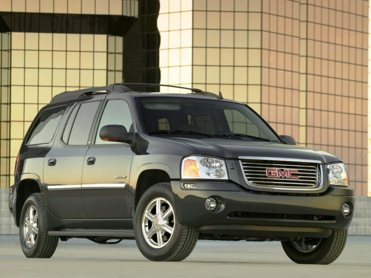 Sleek And Stylish Gmc Envoy On The Road Wallpaper