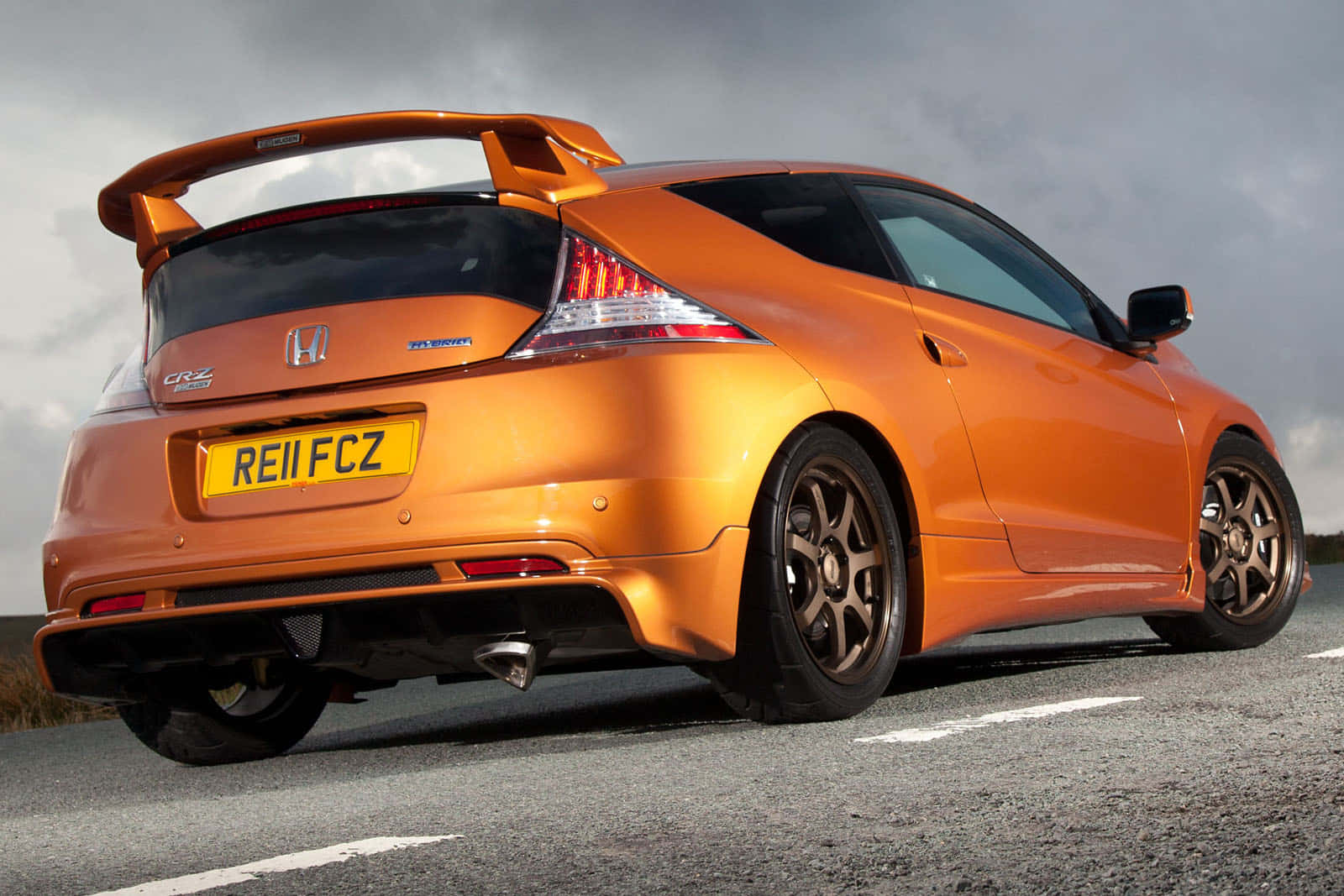 Sleek And Stylish Honda Cr-z On The Road Wallpaper