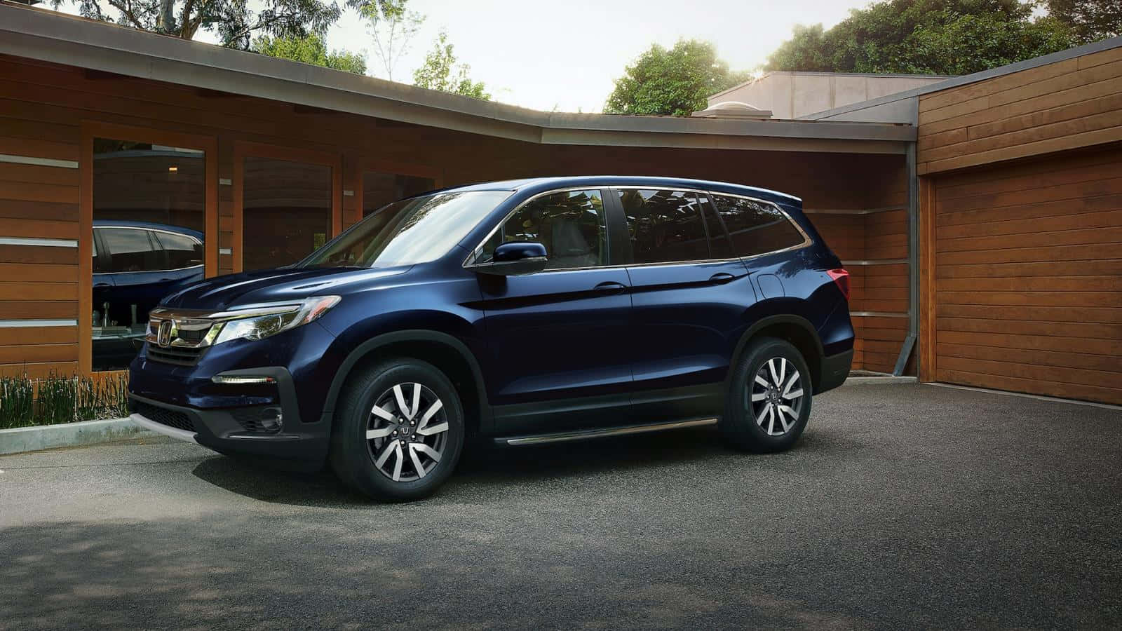 Sleek And Stylish Honda Pilot On A Scenic Road Wallpaper