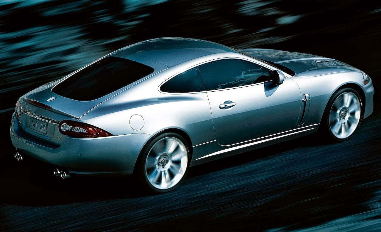 Sleek And Stylish Jaguar Xkr In Motion Wallpaper