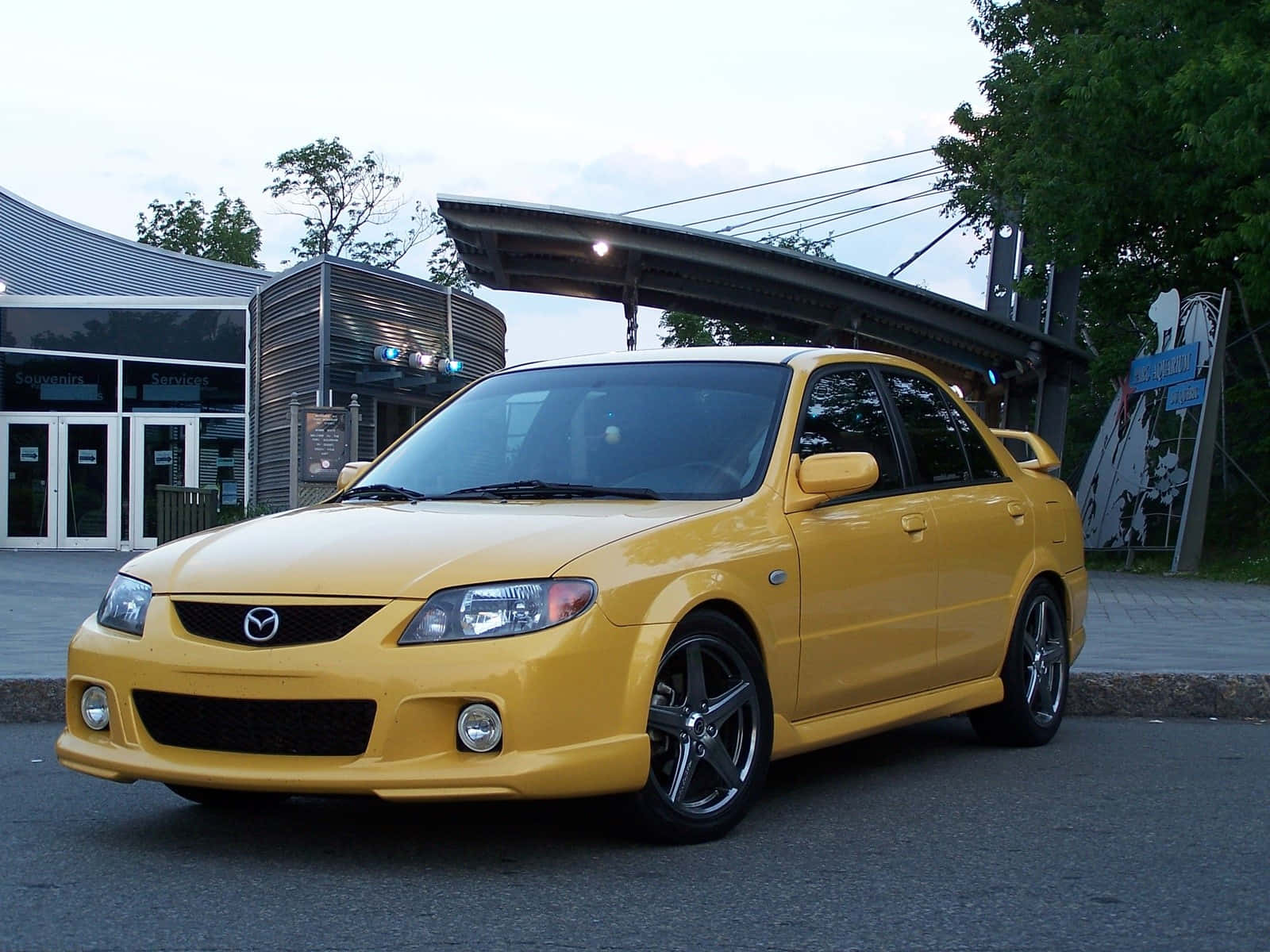 Sleek And Stylish Mazda Protege In Vibrant Red Wallpaper