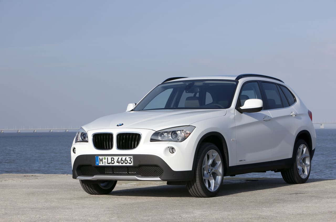 Sleek And Stylish: The Bmw X1 In Motion Wallpaper