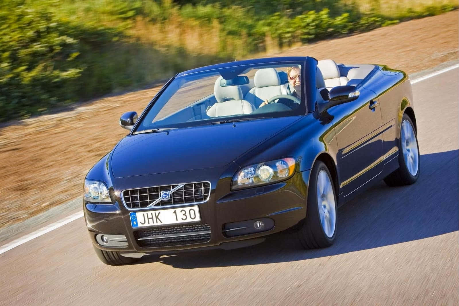 Sleek And Stylish Volvo C70 Cruising Downtown Wallpaper