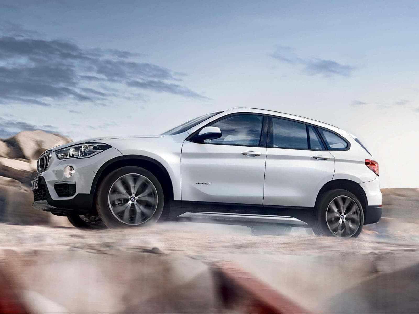 Sleek And Versatile Bmw X1 On The Road Wallpaper