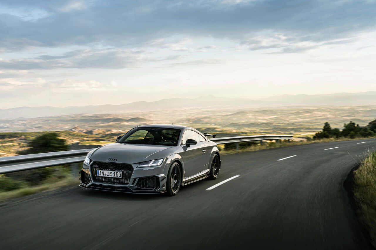 Sleek Audi Tt Rs On The Road Wallpaper