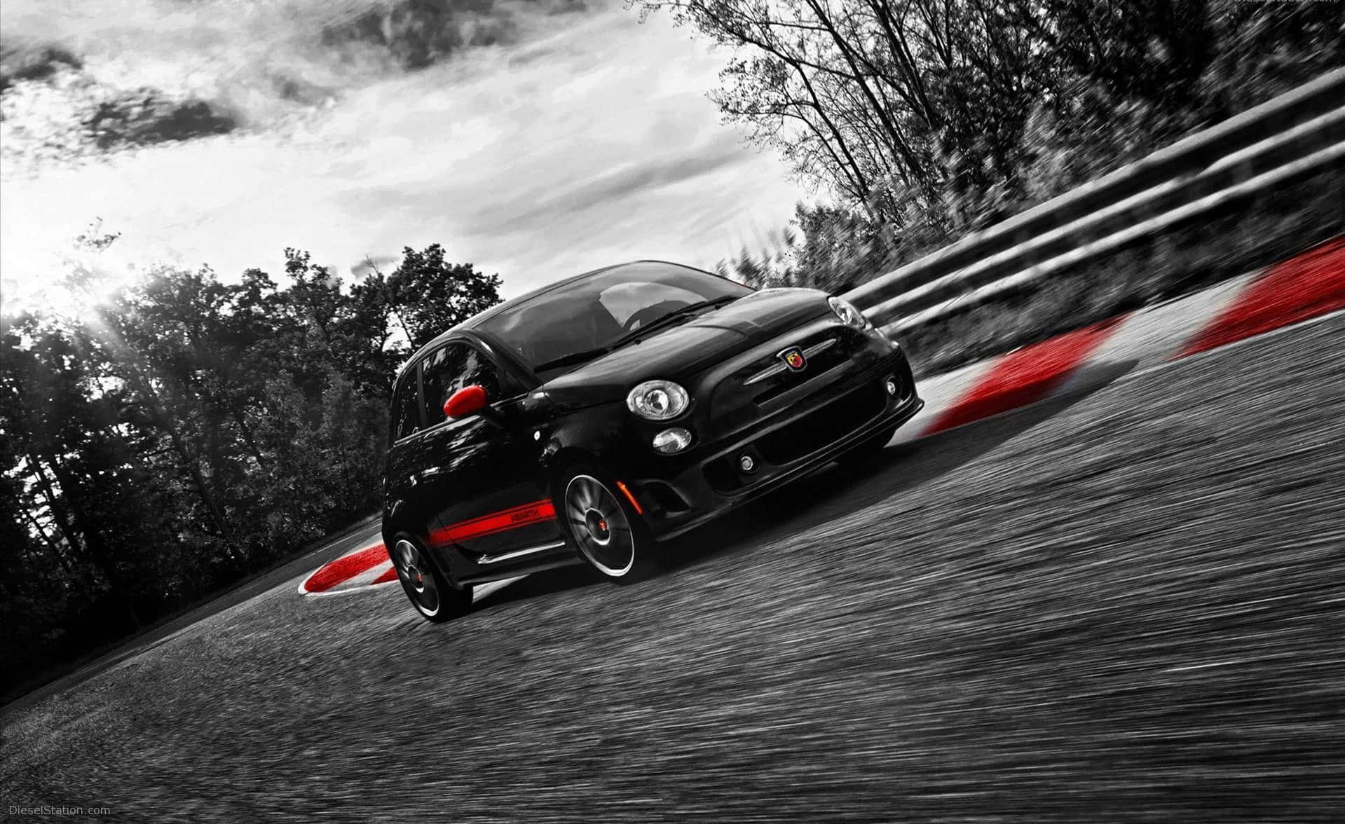 Sleek Black Abarth 595 On City Streets Wallpaper