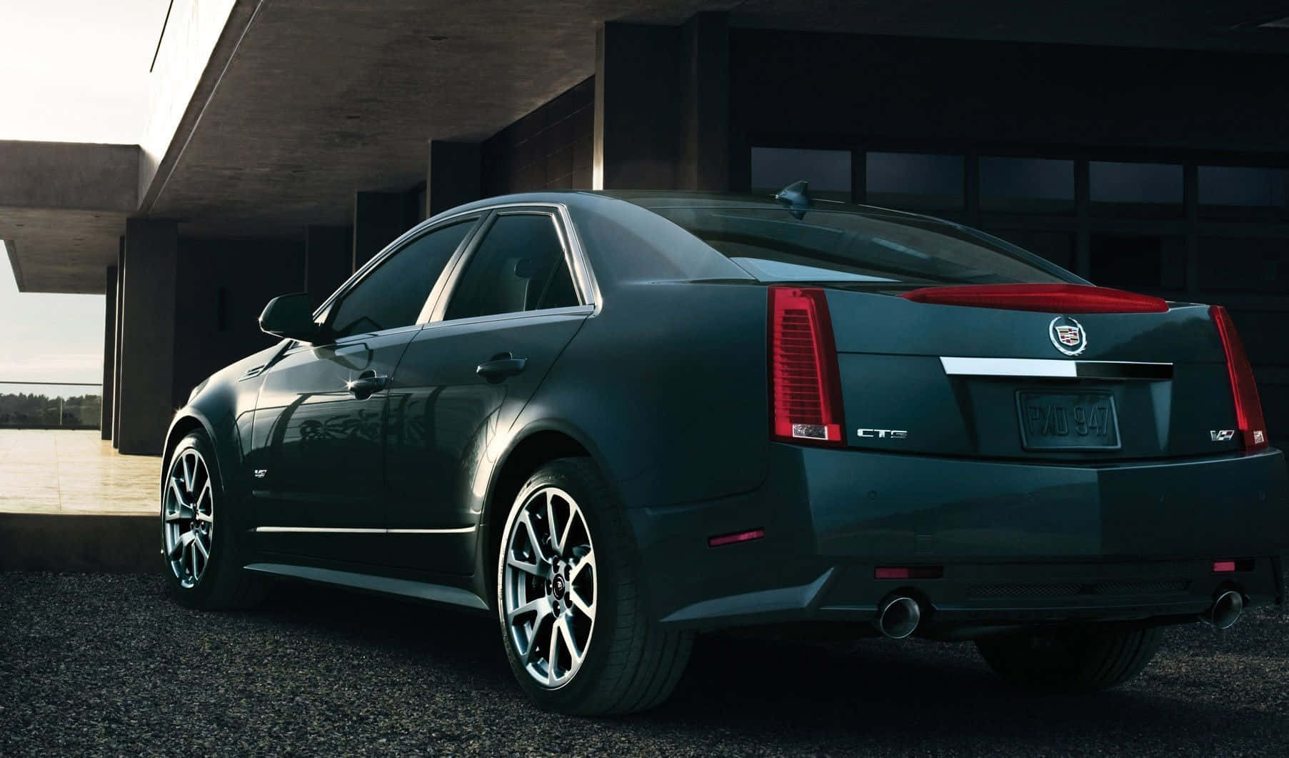 Sleek Black Cadillac Cts On City Street Wallpaper