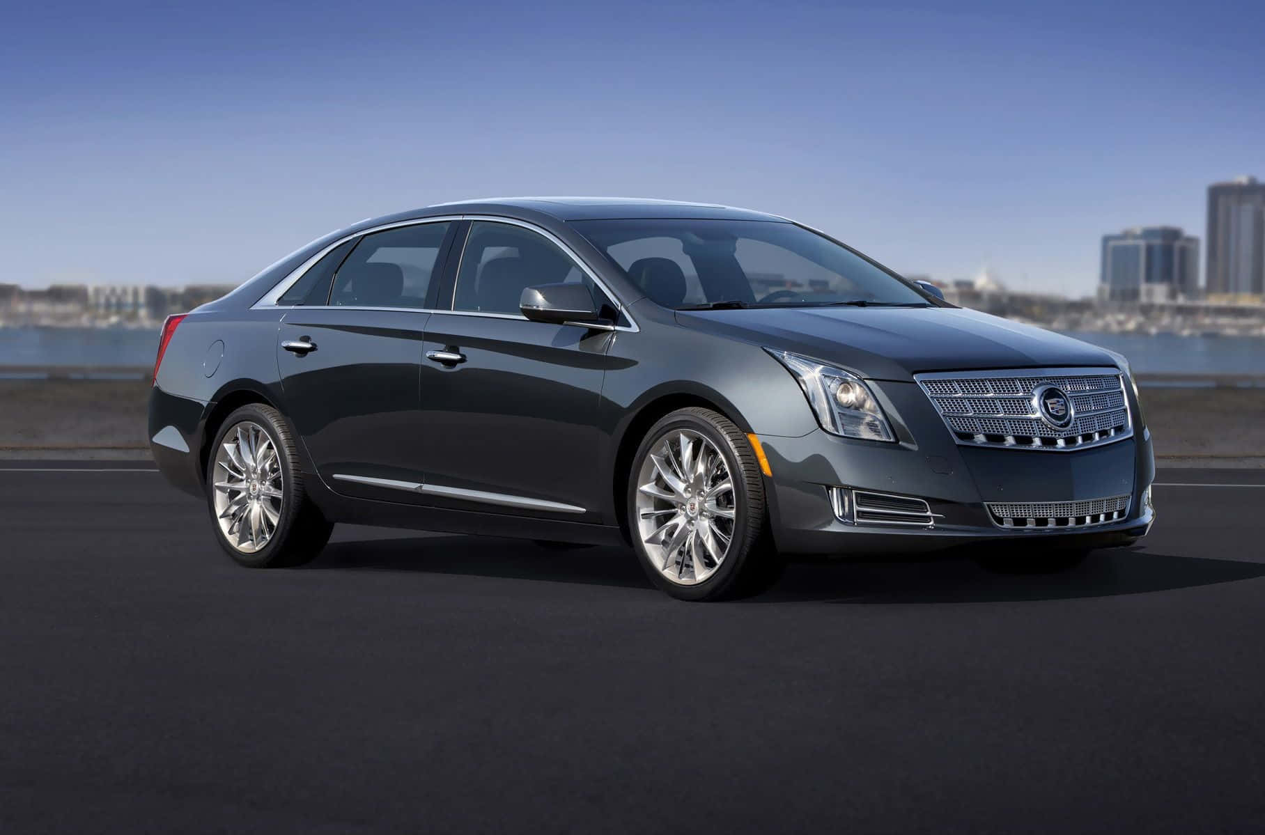 Sleek Black Cadillac Xts Parked On A City Street Wallpaper