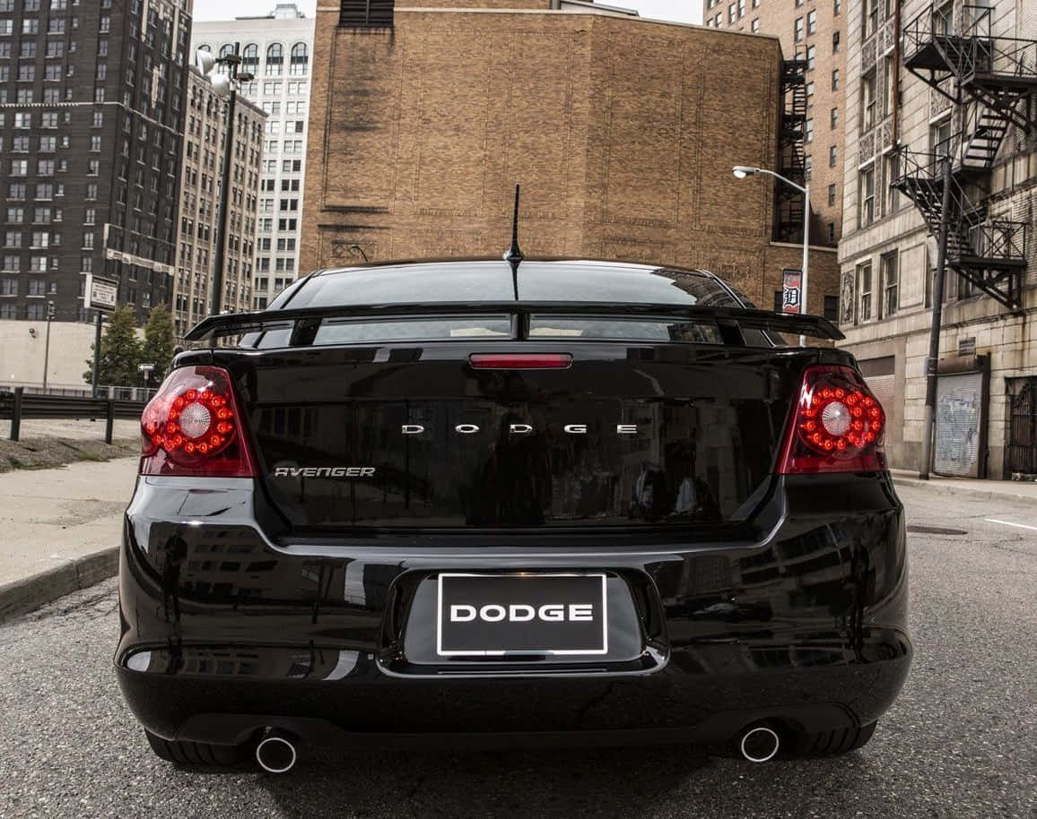 Sleek Black Dodge Avenger Under Sky= Wallpaper