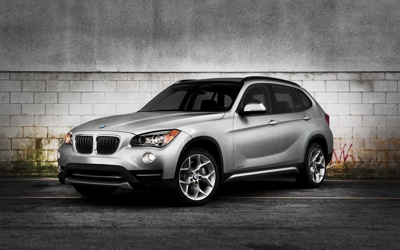 Sleek Bmw X1 Cruising On The Road Wallpaper