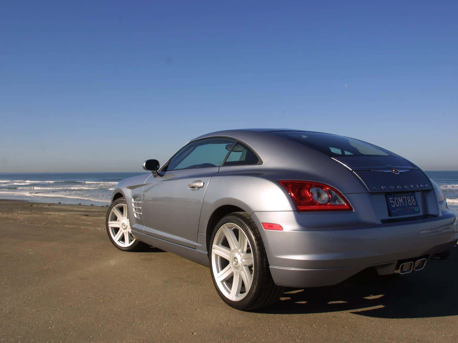 Sleek Chrysler Crossfire Cruising On The Open Road Wallpaper