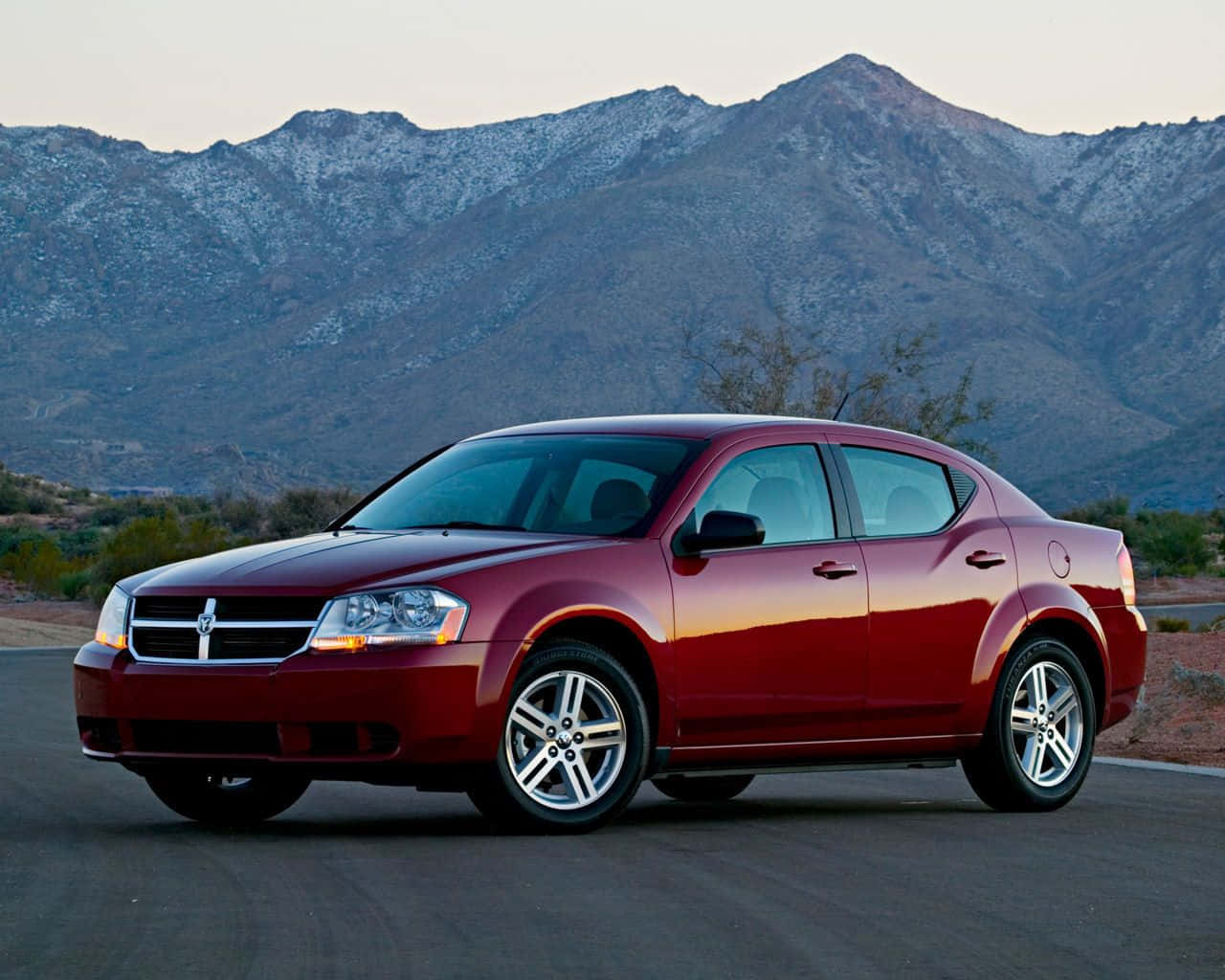 Sleek Dodge Avenger In Night Cityscape Wallpaper