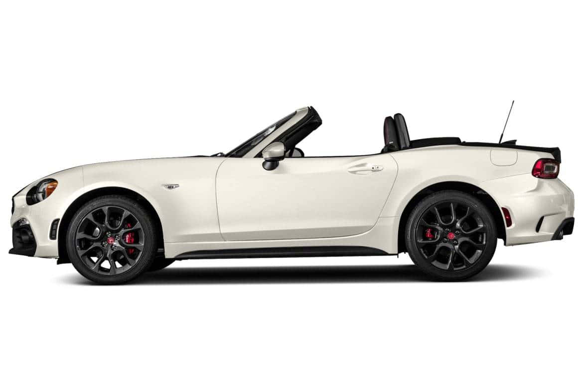 Sleek Fiat 124 Spider Cruising Down The Open Road Wallpaper