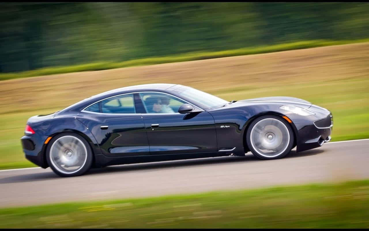 Sleek Fisker Karma Electric Vehicle In A Stunning Outdoor Setting Wallpaper