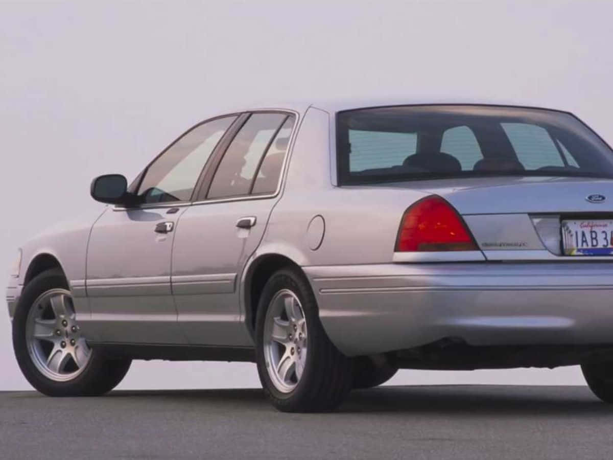 Sleek Ford Crown Victoria In A Stunning Outdoor Setting Wallpaper