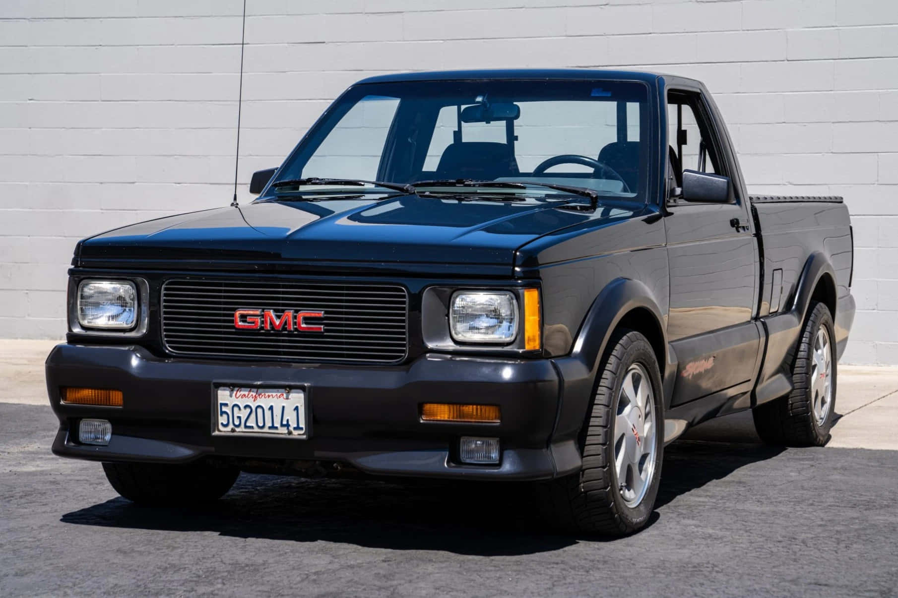 Sleek Gmc Syclone Parked In Dramatic Urban Setting Wallpaper