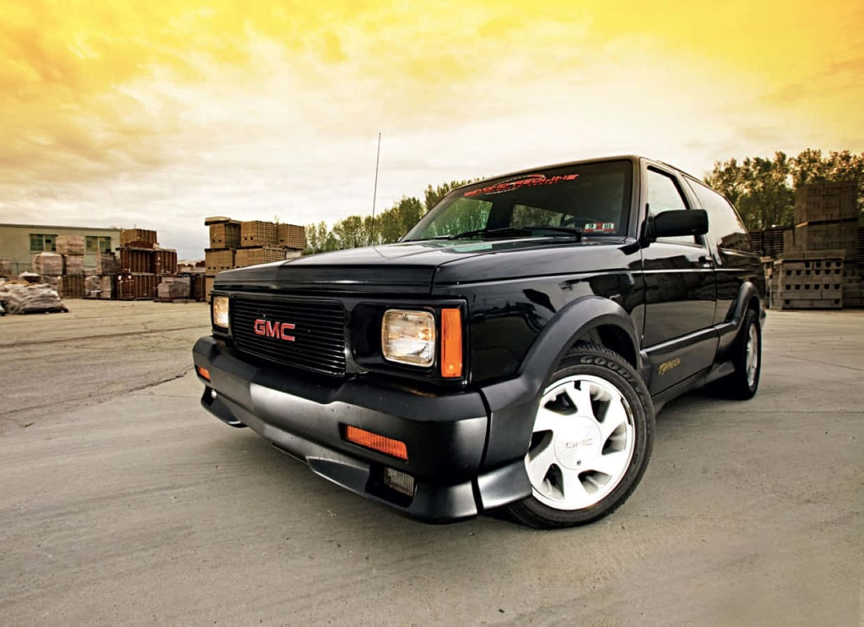 Sleek Gmc Typhoon On The Road Wallpaper