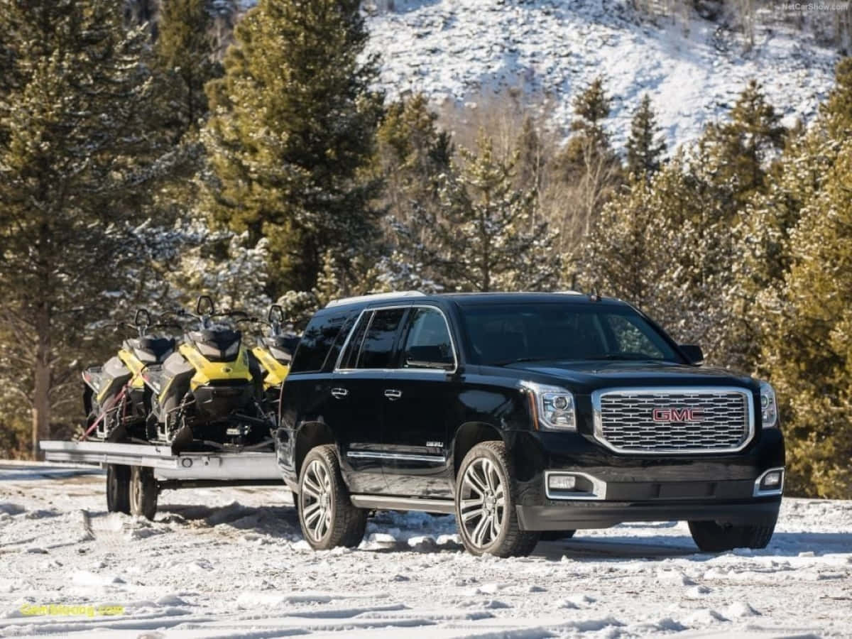 Sleek Gmc Yukon On The Road Wallpaper