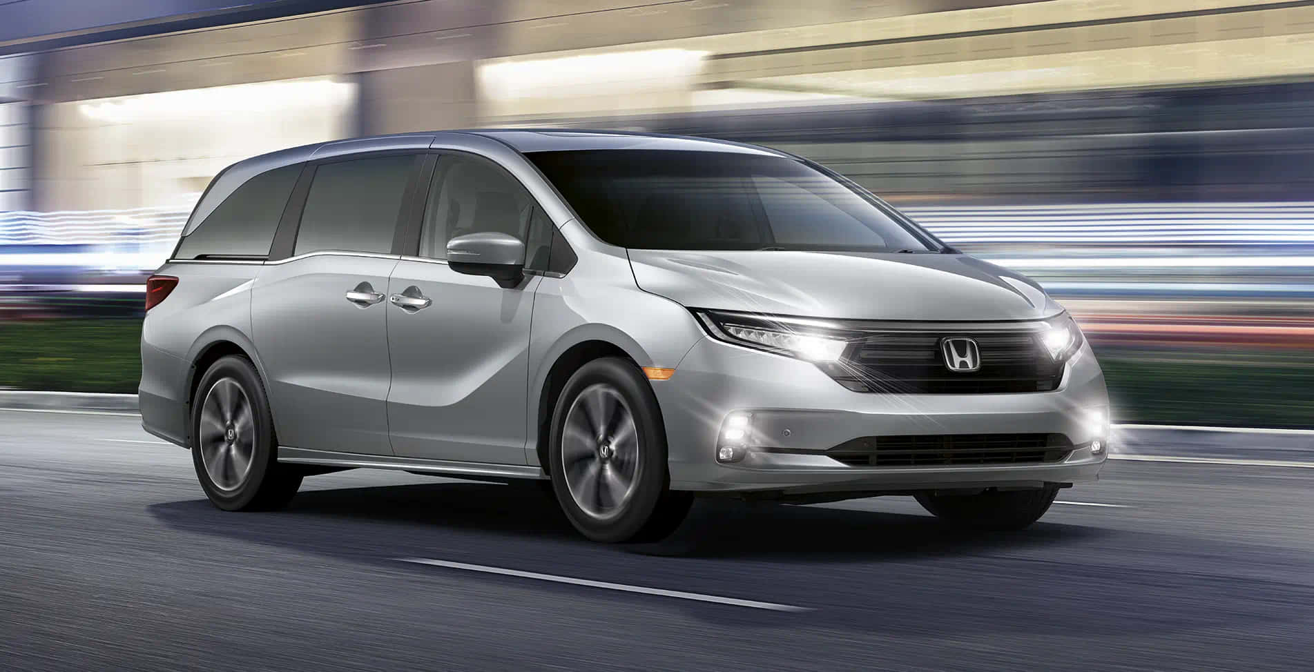 Sleek Honda Odyssey Driving On Open Road Wallpaper