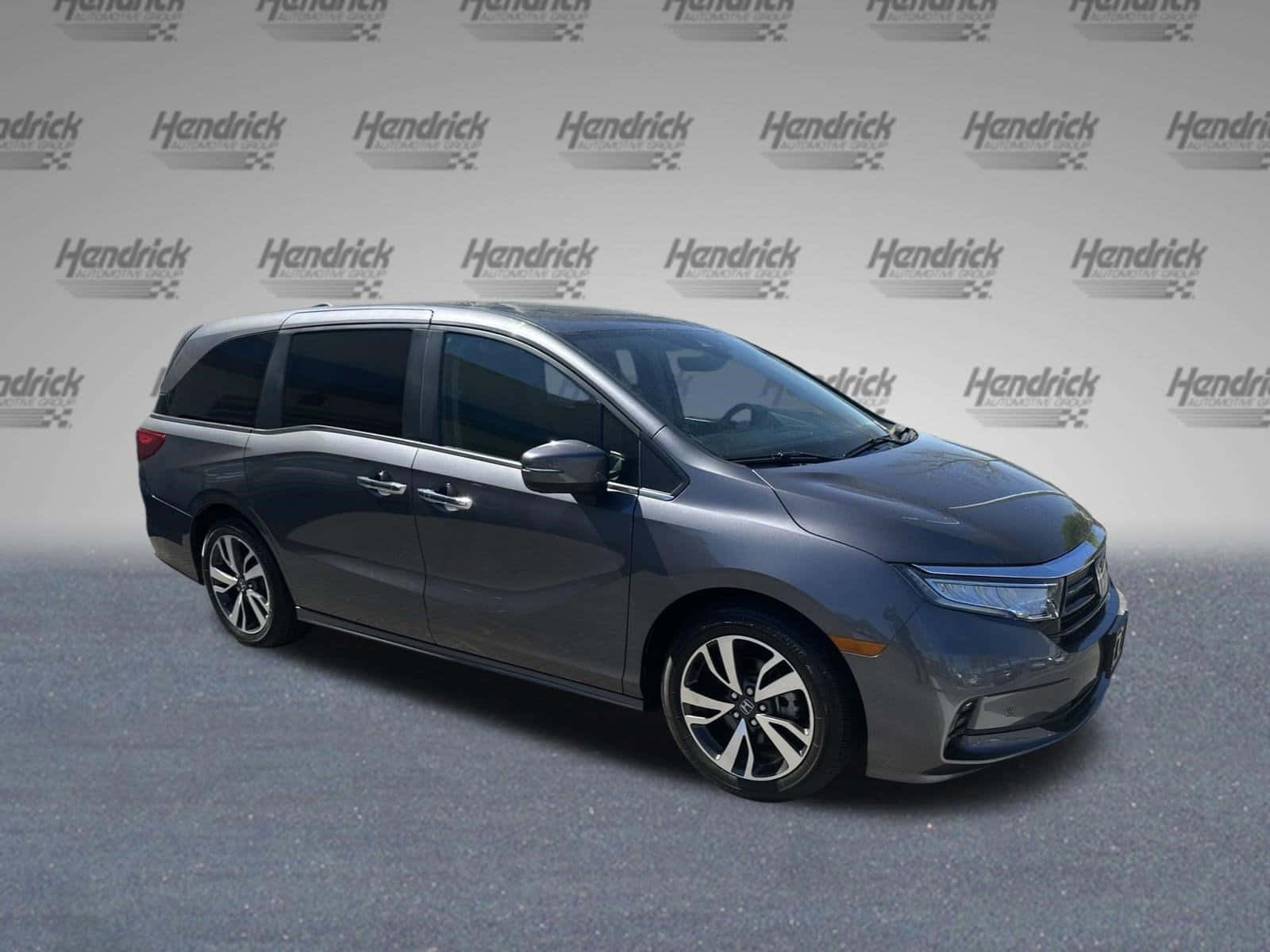 Sleek Honda Odyssey Minivan On A Scenic Highway Wallpaper