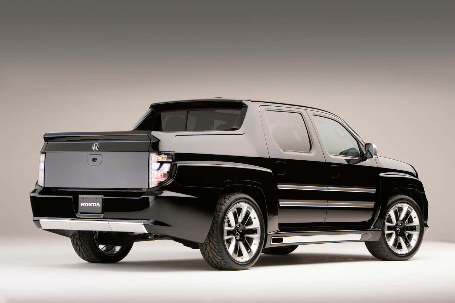 Sleek Honda Ridgeline Driving Through A Picturesque Landscape Wallpaper