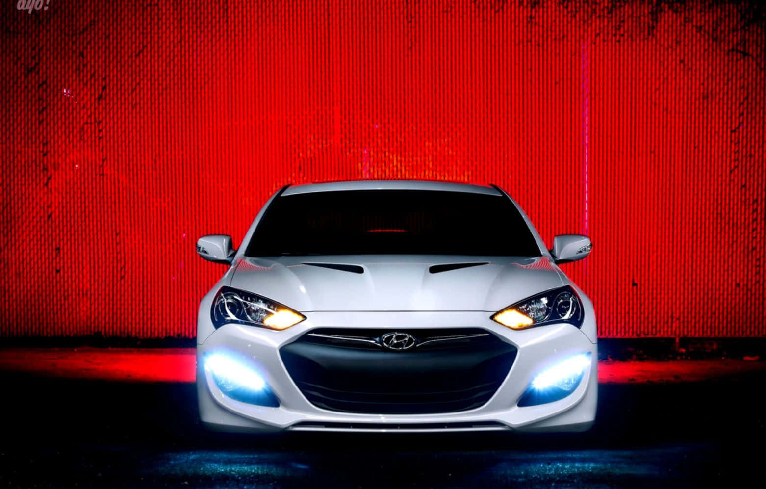 Sleek Hyundai Genesis Cruising The Streets Wallpaper