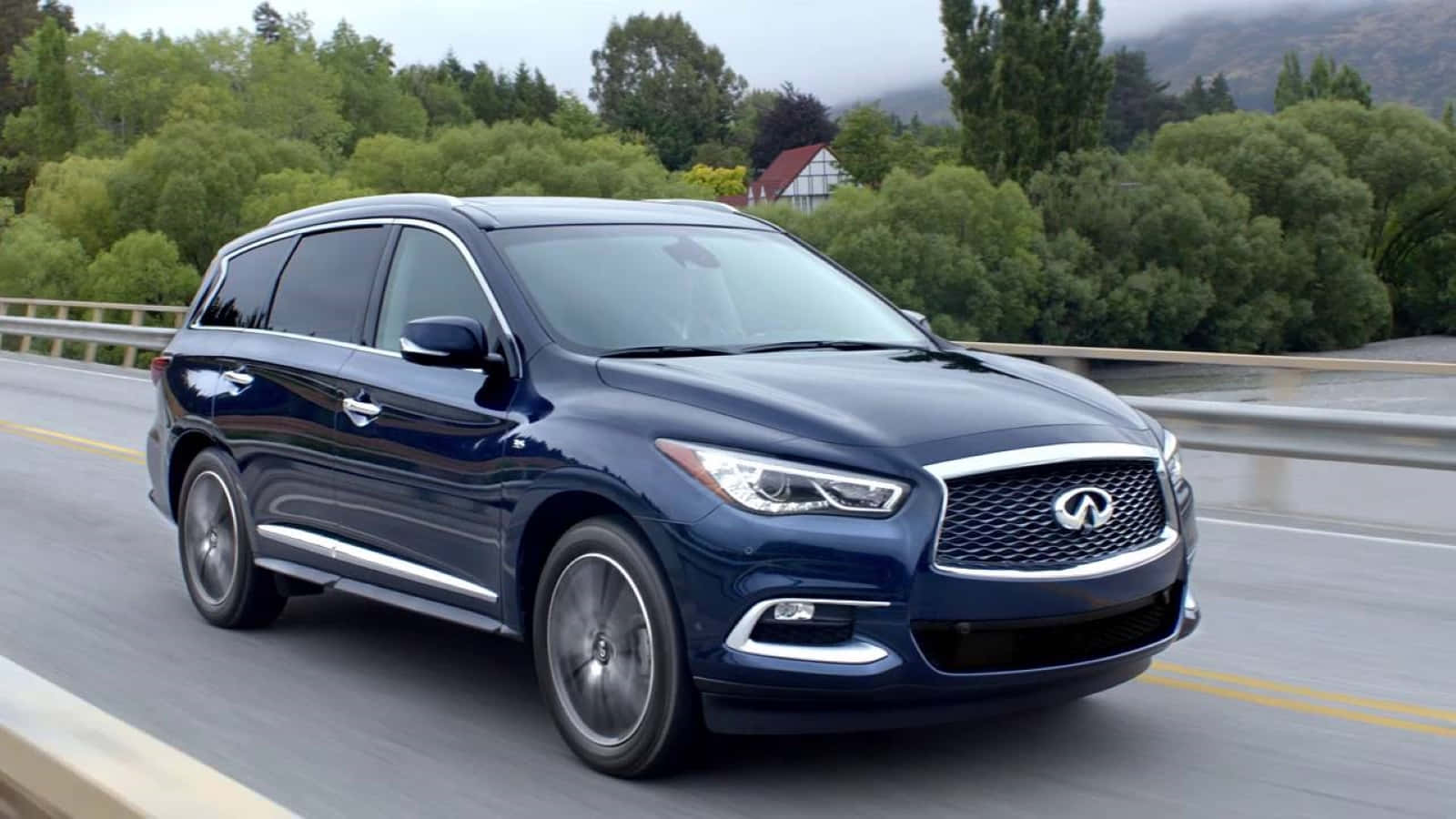 Sleek Infiniti Qx60 Gliding Effortlessly On An Open Road Wallpaper