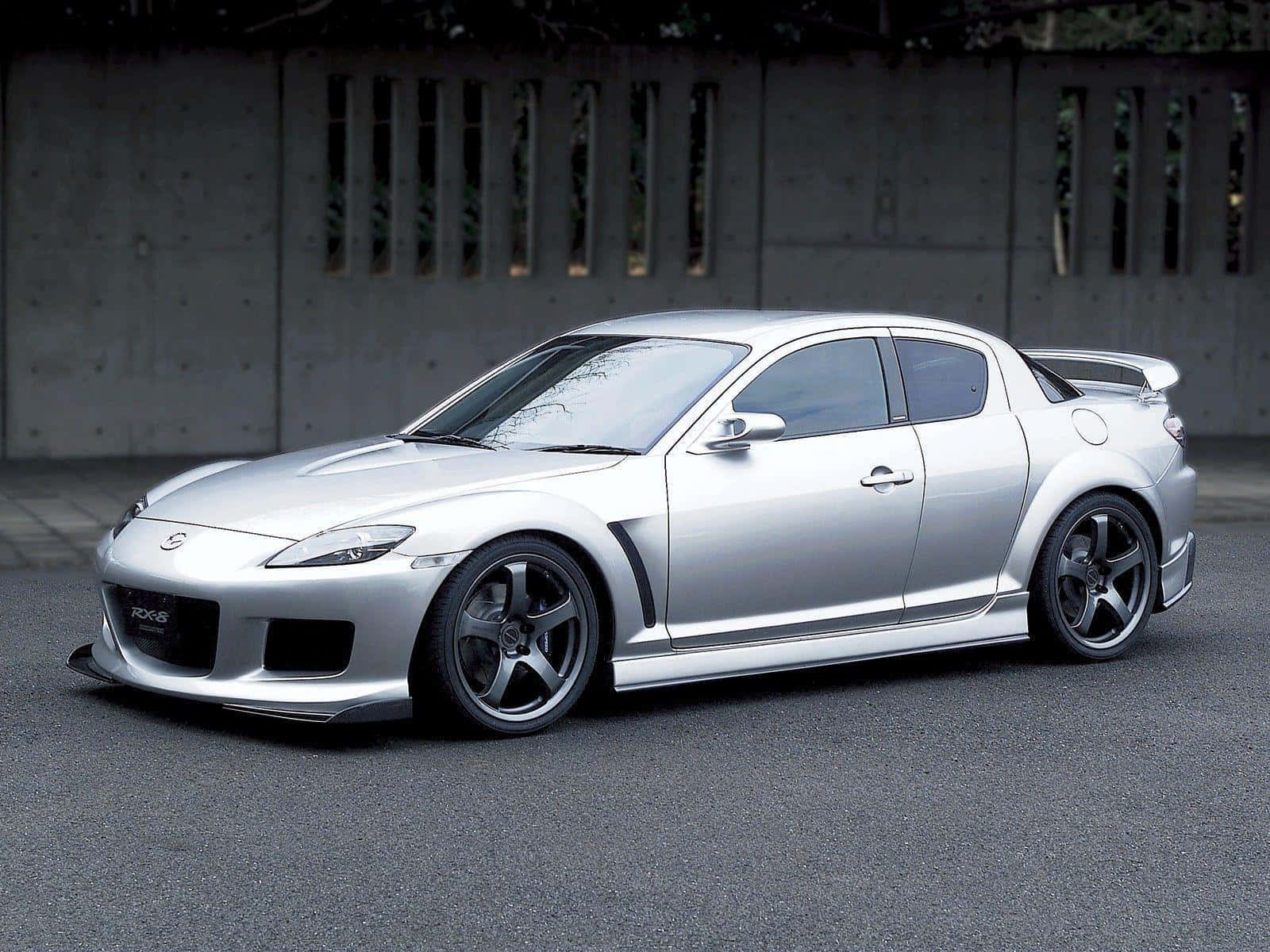 Sleek Mazda Rx-8 On The Road Wallpaper