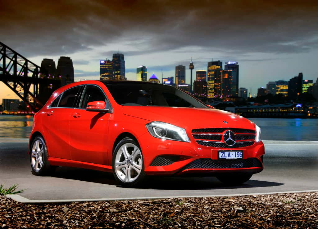 Sleek Mercedes A-class On A Vibrant City Street Wallpaper