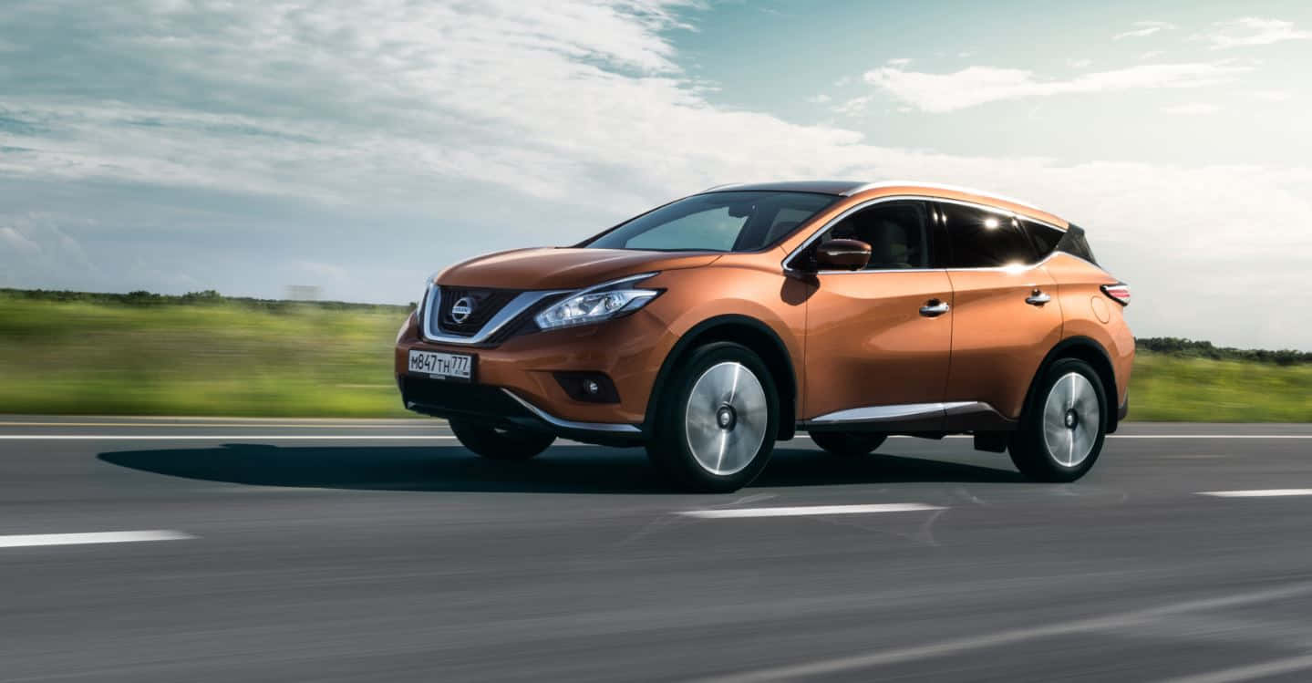 Sleek Nissan Murano Cruising On An Open Road Wallpaper