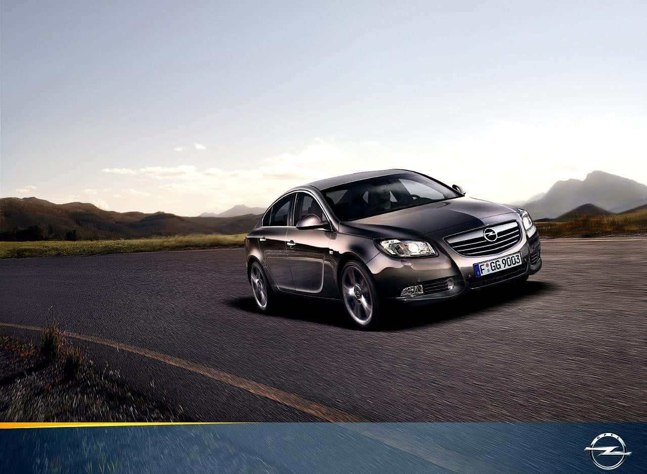 Sleek Opel Insignia Gliding On An Open Road Wallpaper