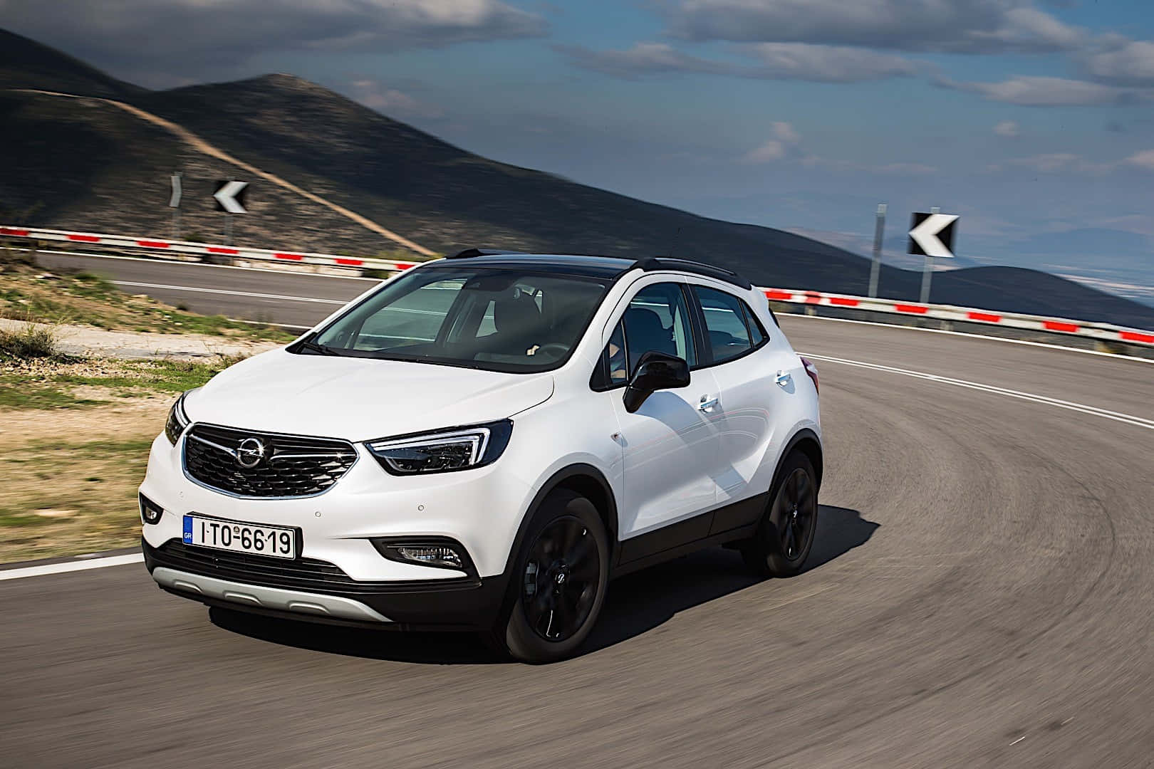 Sleek Opel Mokka Cruising On A Scenic Road Wallpaper