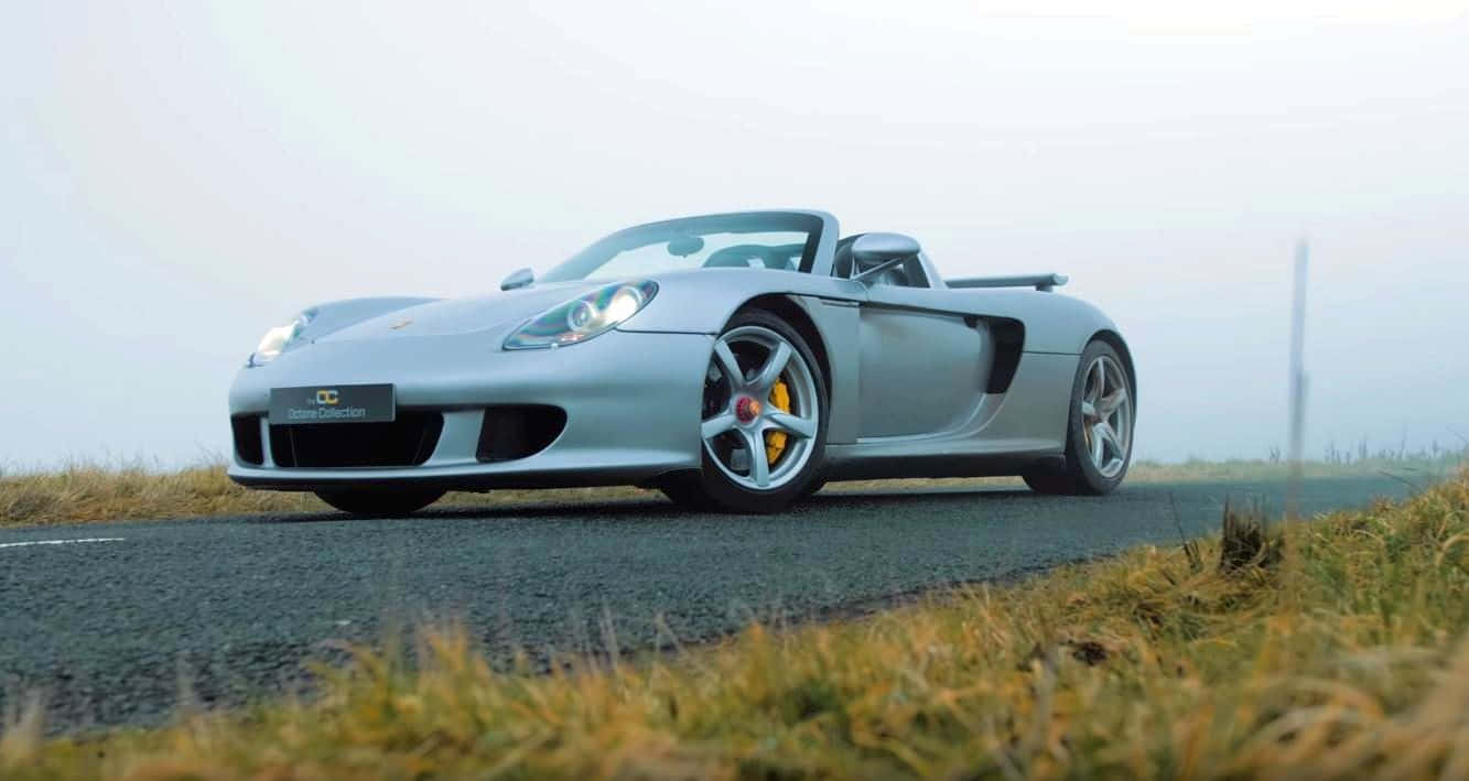 Sleek Porsche Carrera Gt In Motion Wallpaper