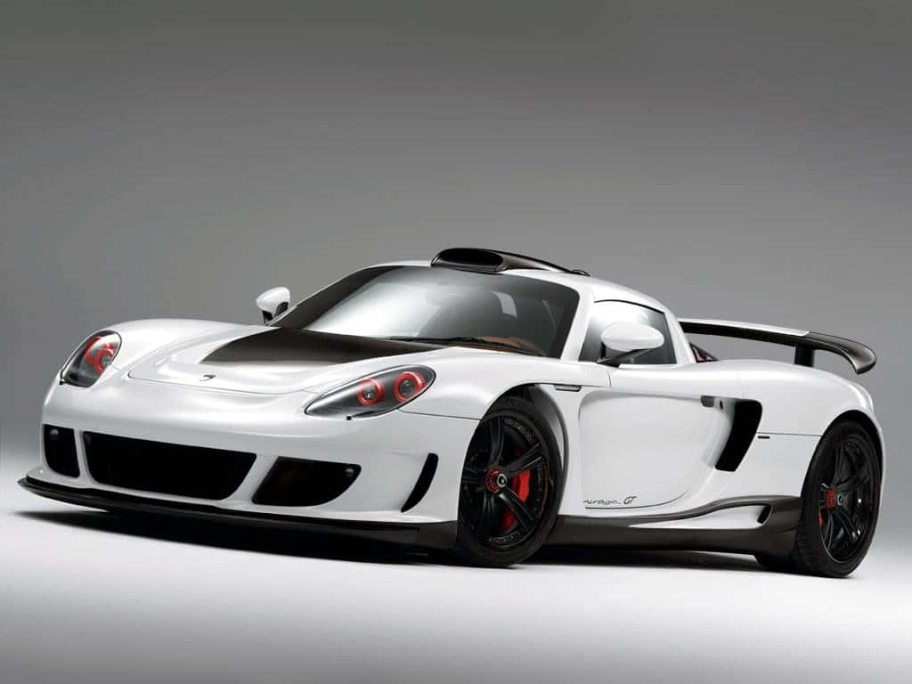 Sleek Porsche Carrera Gt Racing On A Scenic Route Wallpaper