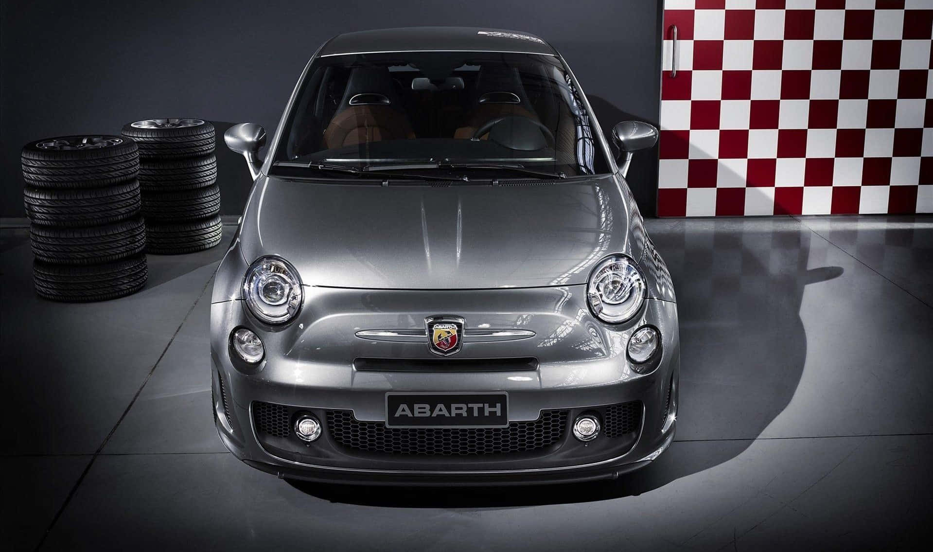 Sleek Red Abarth Racing On The Track Wallpaper