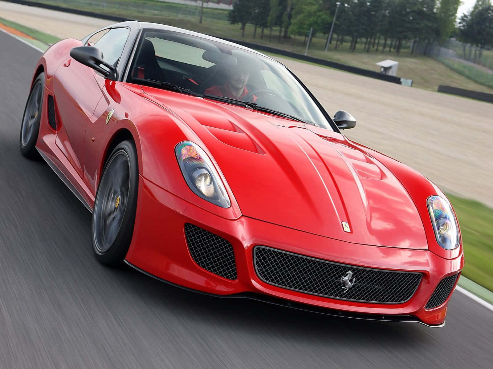 Sleek Red Ferrari 599 Gtb Fiorano On The Open Road Wallpaper