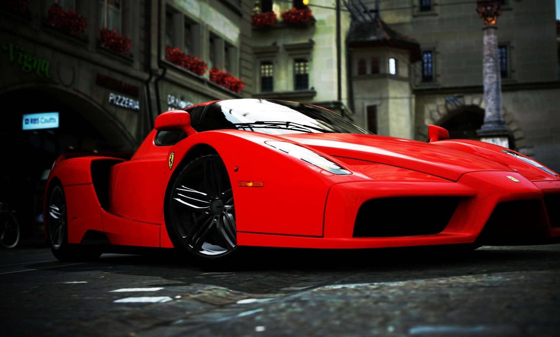 Sleek Red Ferrari Enzo In Action Wallpaper