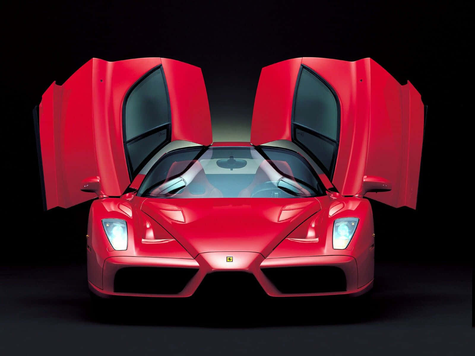 Sleek Red Ferrari Enzo In Action Wallpaper