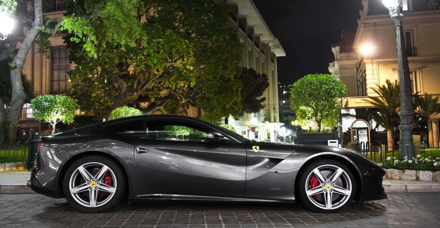 Sleek Red Ferrari F12 Berlinetta In Motion Wallpaper